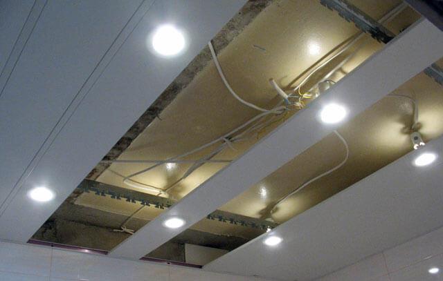 Installation of a grid ceiling with illuminators.
