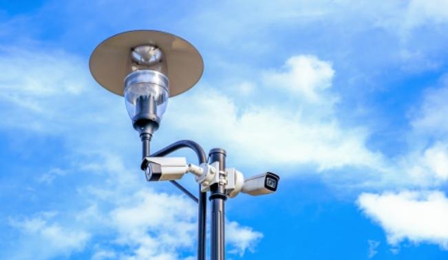 One lamp on a corner can illuminate the space for two cameras located in different directions.