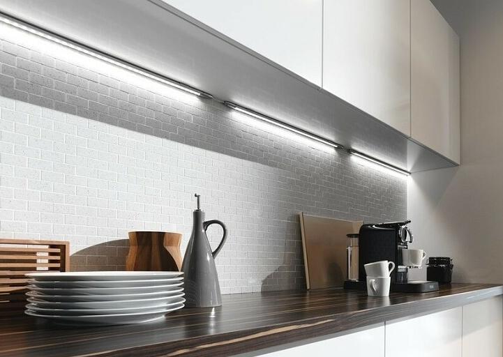 A variety of strip or strip light fittings mounted in the corner between cabinets and the wall.