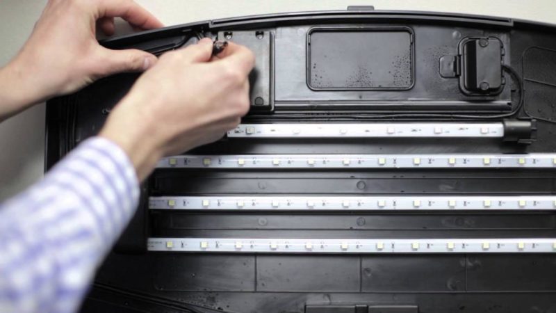 Installing the LED strips under the cover.